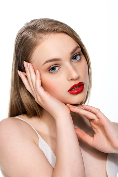pretty young woman with blue eyes and red lips looking at camera isolated on white - 写真・画像