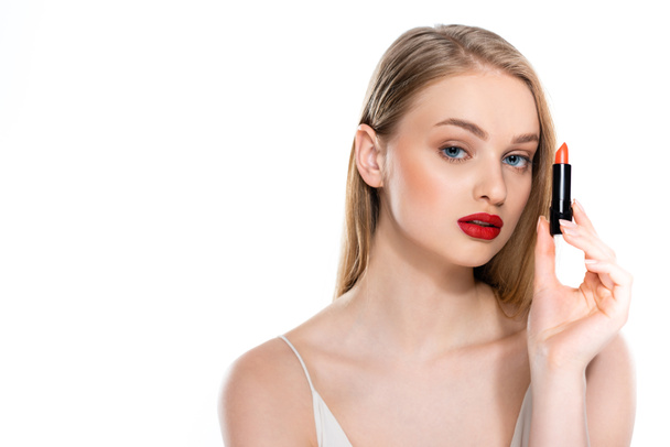 pretty woman with red lips holding lipstick tube isolated on white - Zdjęcie, obraz