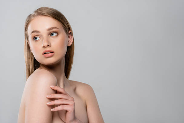 pretty young woman with bare shoulders looking away isolated on grey - Photo, Image