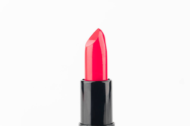 Red lipsticks in black tube package isolated on white background. Makeup and cosmetics concept. Close up. - Photo, Image