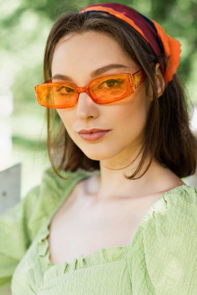 Pretty woman in sunglasses and headscarf outdoors  - Zdjęcie, obraz