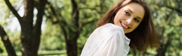 Smiling woman in white dress in summer park, banner  - Foto, afbeelding