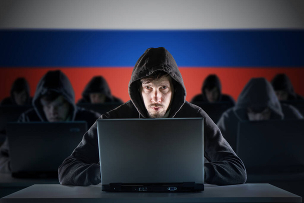 Trol çiftliğinde birçok Rus bilgisayar korsanı var. Siber suç ve güvenlik kavramı. Arka planda Rusya bayrağı. - Fotoğraf, Görsel