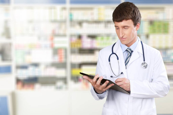 Hands of young pharmacist checking inventory in medical store using a digital tablet - Photo, Image