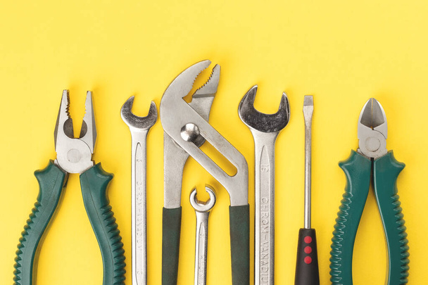 Work tools on bright yellow background. Top view, flat lay - Photo, Image