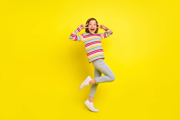 Full body photo of funky short hairdo small girl show v-sign wear shirt trousers isolated on yellow color background - Foto, immagini