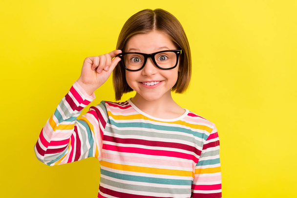 Photo of charming adorable young small girl wear glasses smile good mood isolated on yellow color background - Fotoğraf, Görsel