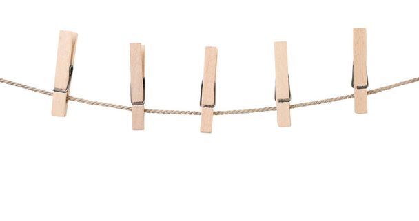 Clothespins on a rope close-up on a white background. Isolated - Photo, Image
