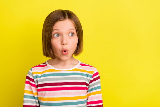 Photo of amazed astonished young little girl look empty space sale shocked isolated on yellow color background - Photo, image