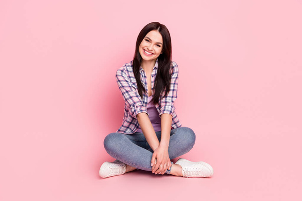 Portrait of attractive cheerful girl sitting lotus pose enjoying good mood isolated over pink pastel color background - Fotografie, Obrázek
