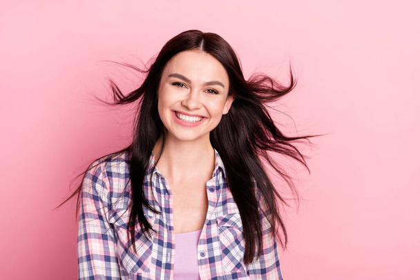 Photo portrait girl in checkered shirt smiling flying hair isolated pastel pink color background - Foto, immagini