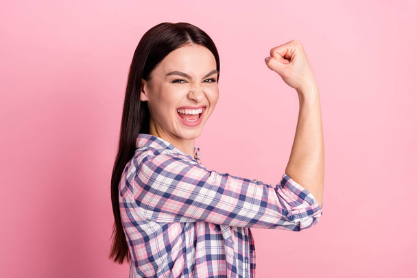 Photo portrait of girl in casual clothes smiling strong feminist showing biceps isolated on pastel pink color background - Foto, afbeelding