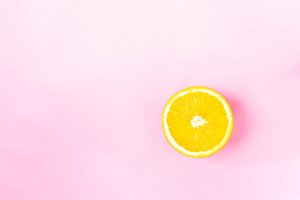 Top view of one orange round fruit on bright blue background. Rich citrus texture. Copy space. - Foto, Imagen