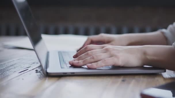 close-up of female hands typing text on laptop keyboard in light modern office. - Filmagem, Vídeo