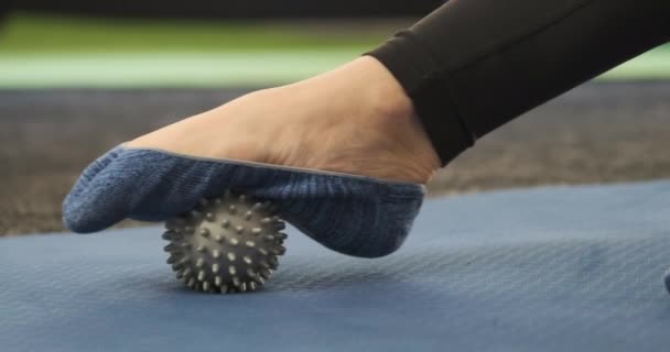 Girl using massage tool for foot massage. Self-massage. MFR. Myofascial release. Myofascial ball.  - Footage, Video