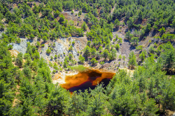 Reforestation of an old copper mine area near Kinousa, Cyprus. Red lake is a result of the pyrite ore extraction in the area - Photo, Image