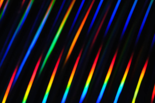 Holographic neon background. Neon rainbow strips on dark background. Soft focus Abstract rainbow color wave strips horizontal background - Photo, image