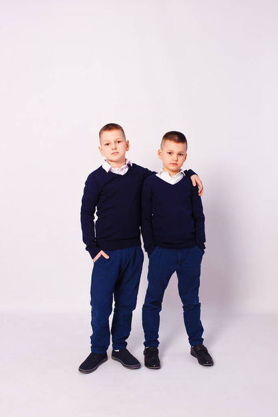 two boys in school clothes on a white background - Photo, image