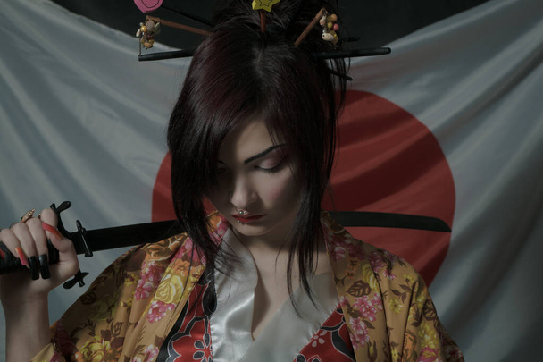Kawaii japanese girl with katana posing over japanese flag - Photo, Image