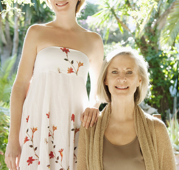 Daughter and mother being together in a home garden - Photo, Image