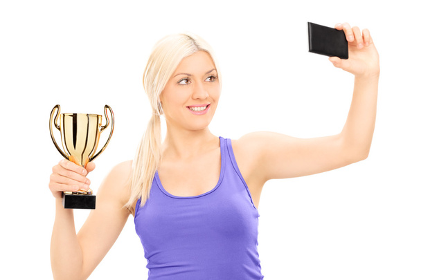 Woman holding trophy - 写真・画像