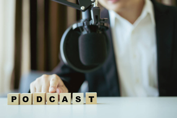 Unrecognizable Asian businessman making his online podcast from home, a businessman talking on the online radio station and using professional condenser microphone. Audio live streaming concept. - Foto, imagen