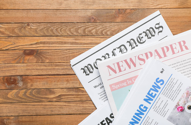 Newspapers on wooden background, closeup - Φωτογραφία, εικόνα