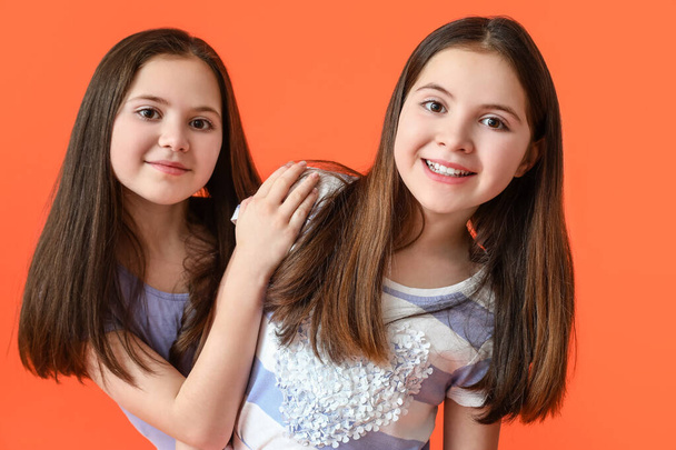 Cute twin girls on color background - Photo, Image