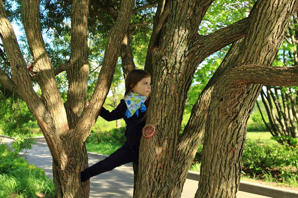 little girl over trees in the park at spring, Moscow, Russia - Foto, immagini