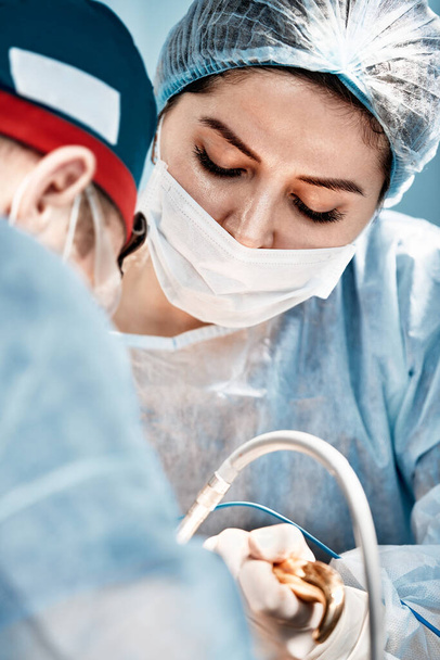 Close-up of surgeons in the operating room during the operation.Modern medicine, Medical workers during the Covid19 coronavirus pandemic fight and save lives. - Photo, Image