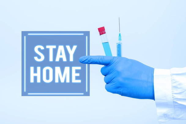 Conceptual caption Stay Home. Word for not go out for an activity and stay inside the house or home Chemist Presenting Infection Cure, Doctor Displaying Virus Vaccine - Foto, Bild