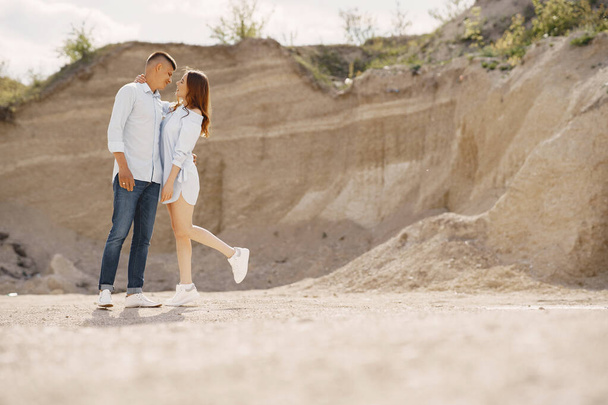 Young couple in love in sand career - Фото, зображення