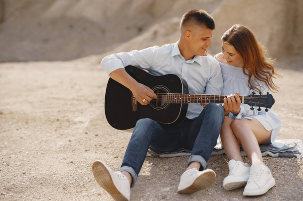 Young couple in love in sand career - Foto, imagen