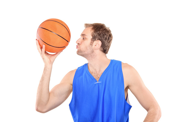 Young sportsman kissing basketball - Fotó, kép