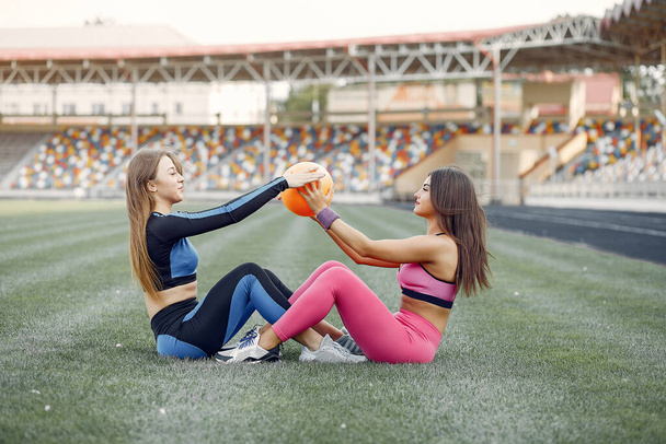 Sports girls in a uniform training at the stadium - Φωτογραφία, εικόνα