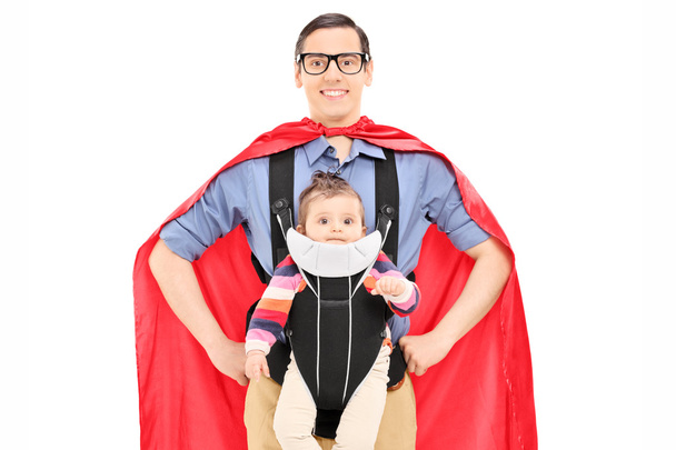 Superhero carrying his baby daughter - Фото, изображение