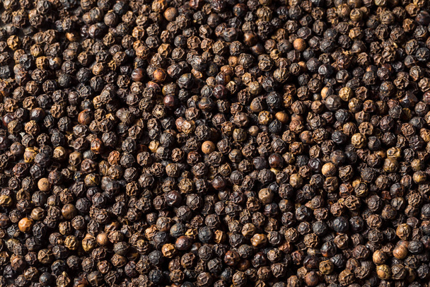 Raw Organic Black Peppercorns in a Bowl - Фото, изображение