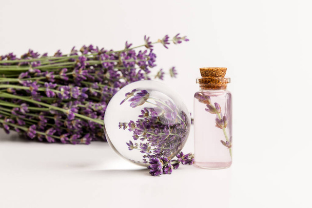 lavender essential oil in a beautiful bottle on the light background - Photo, Image