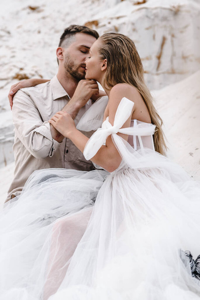Beautiful wedding couple bride and groom at wedding day outdoors at ocean beach. Happy marriage - Zdjęcie, obraz