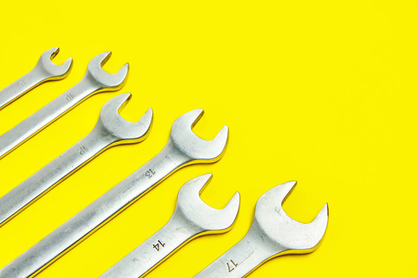 Set of wrenches on a yellow background - Fotó, kép