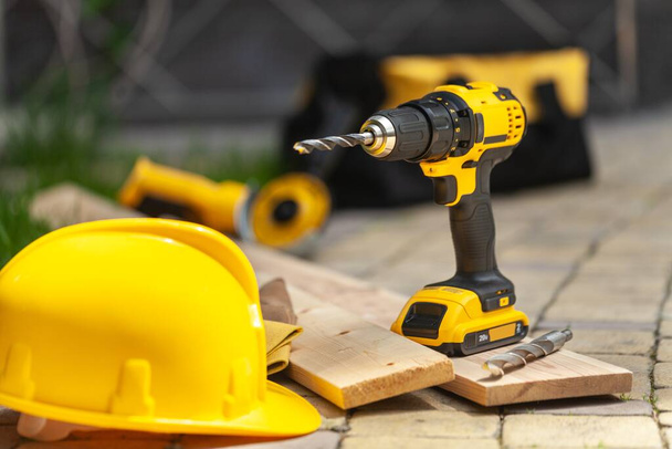 Construction carpentry tools electric corded circular saw cordless drill on background - 写真・画像