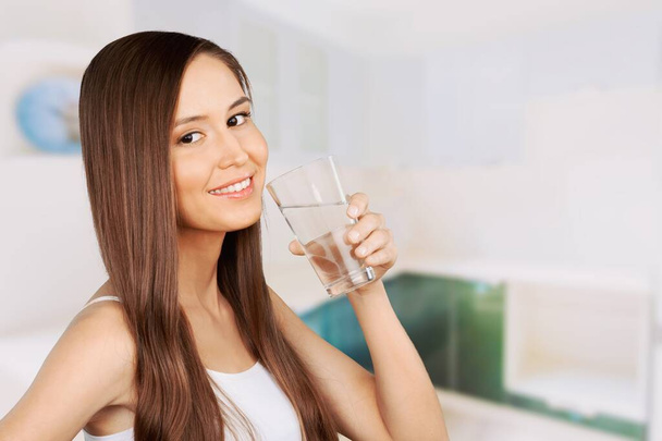 Healthy Liquid. Beautiful Brunette Woman Drinking Water From Glass In Kitchen, - Foto, imagen