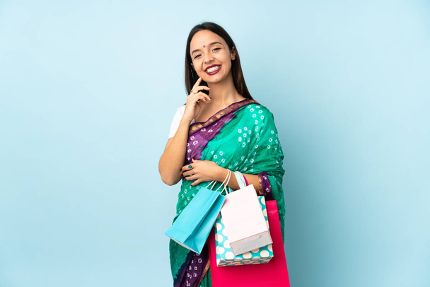 Young Indian woman with shopping bags laughing - Foto, Bild