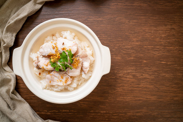 porridge or boiled rice soup with fish bowl - Valokuva, kuva
