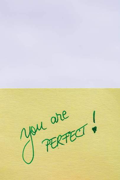A handwriting text saying 'you are perfect' on a yellow paper - Foto, immagini