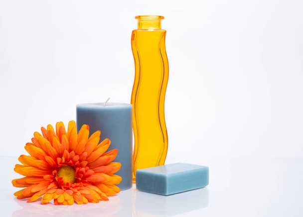 A closeup shot of a decorative yellow vase and candles with a flower on an isolated background - Valokuva, kuva