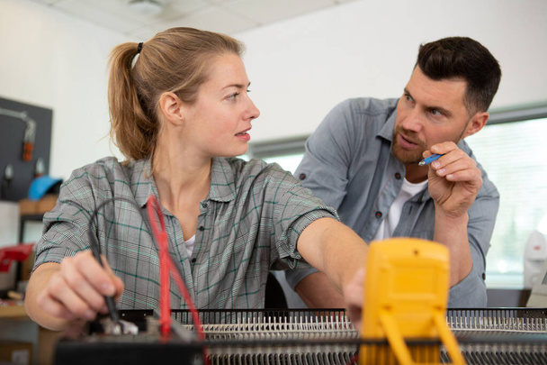 side view of female engineer and man with voltage - Photo, Image