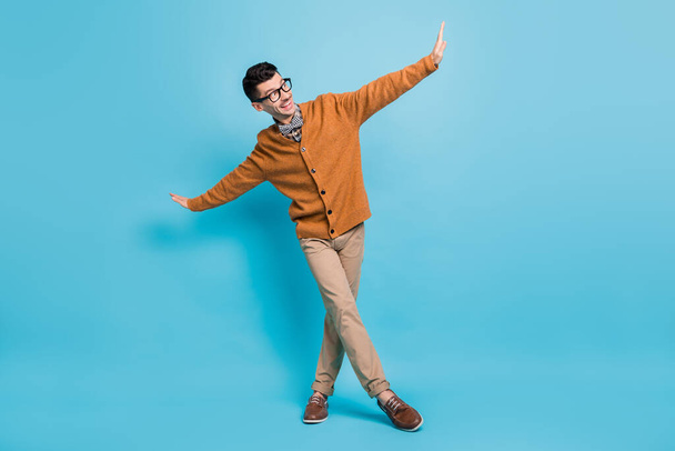 Full length photo of charming happy funky man dance good mood isolated on pastel blue color background - Foto, imagen