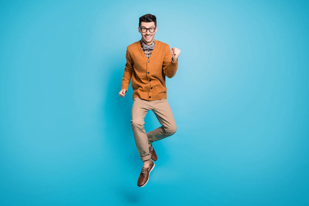 Full body photo of young hipster man happy rejoice win victory fists hands isolated over blue color background - Фото, зображення