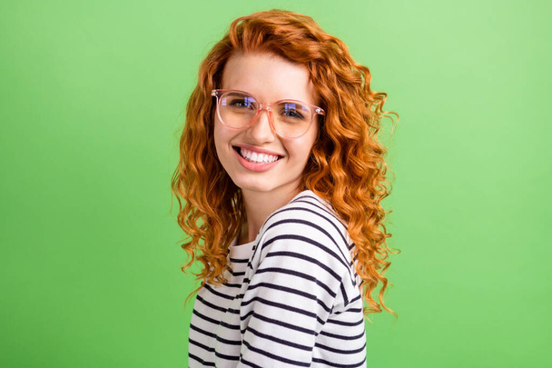 Photo of shiny adorable young lady dressed striped clothes glasses smiling isolated green color background - Fotoğraf, Görsel
